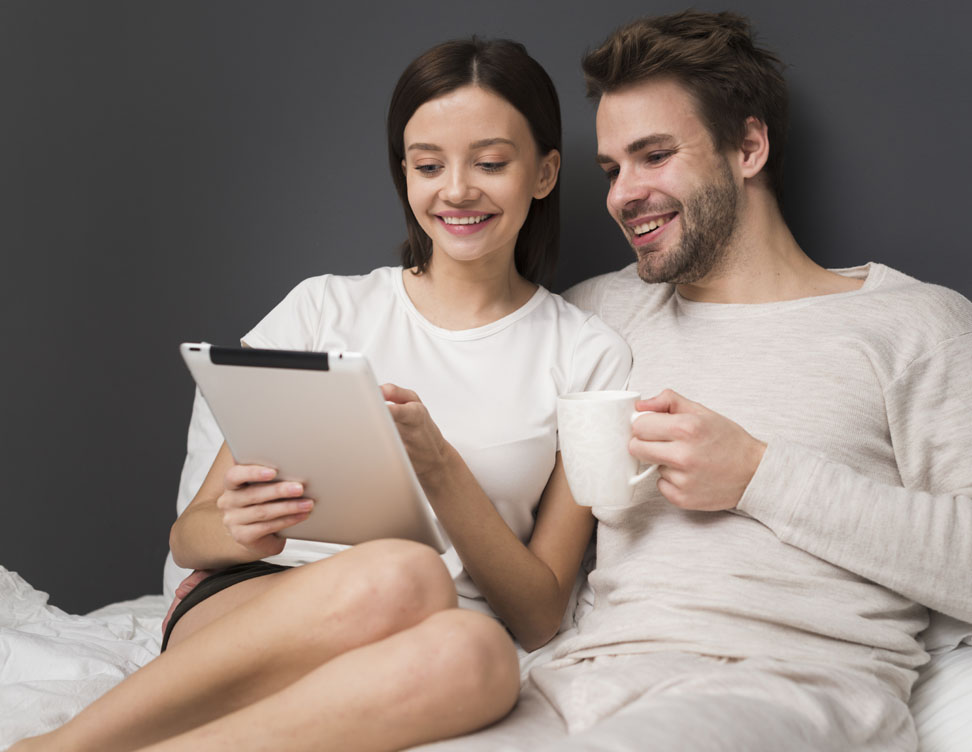Couple comfortably shopping at home for storm doors on bwjstorm.com