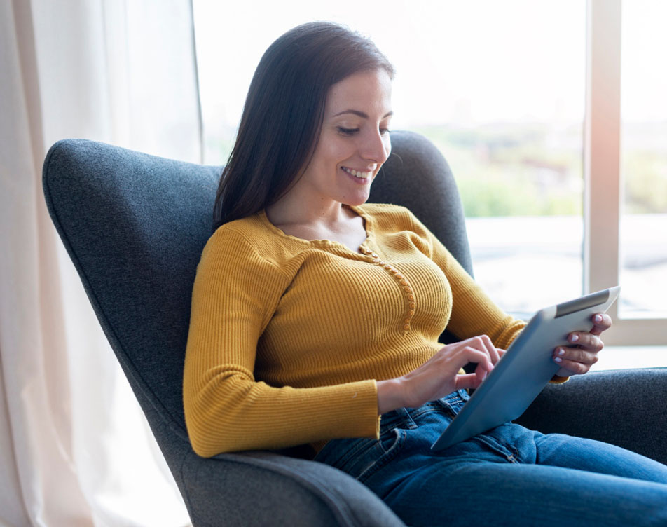 Woman comfortably shopping at home for storm doors at bwjstorm.com